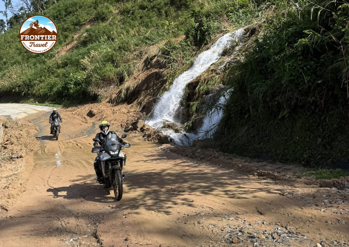 Rider navigating muddy off-road paths on a Vietnam motorbike journey